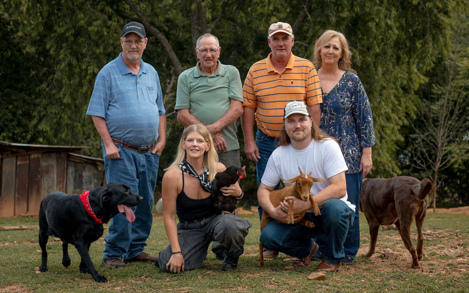 chip-photo-3 Candidate for Woodfin Town Council Maxwell Chip Parton III and his fiancée, family, two dogs, a goat, and chicken pose for a group photo.